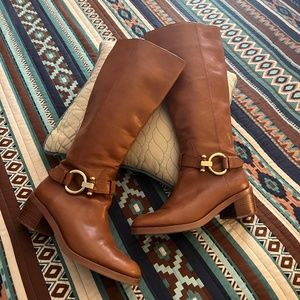 Coach leather boots in tan cognac color with side zip and buckle details.